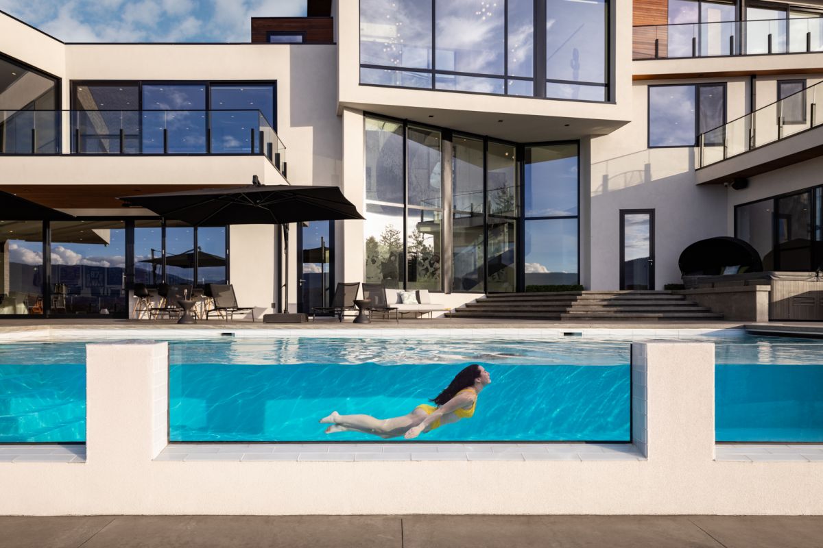 Mansion swimming pool with woman underwater