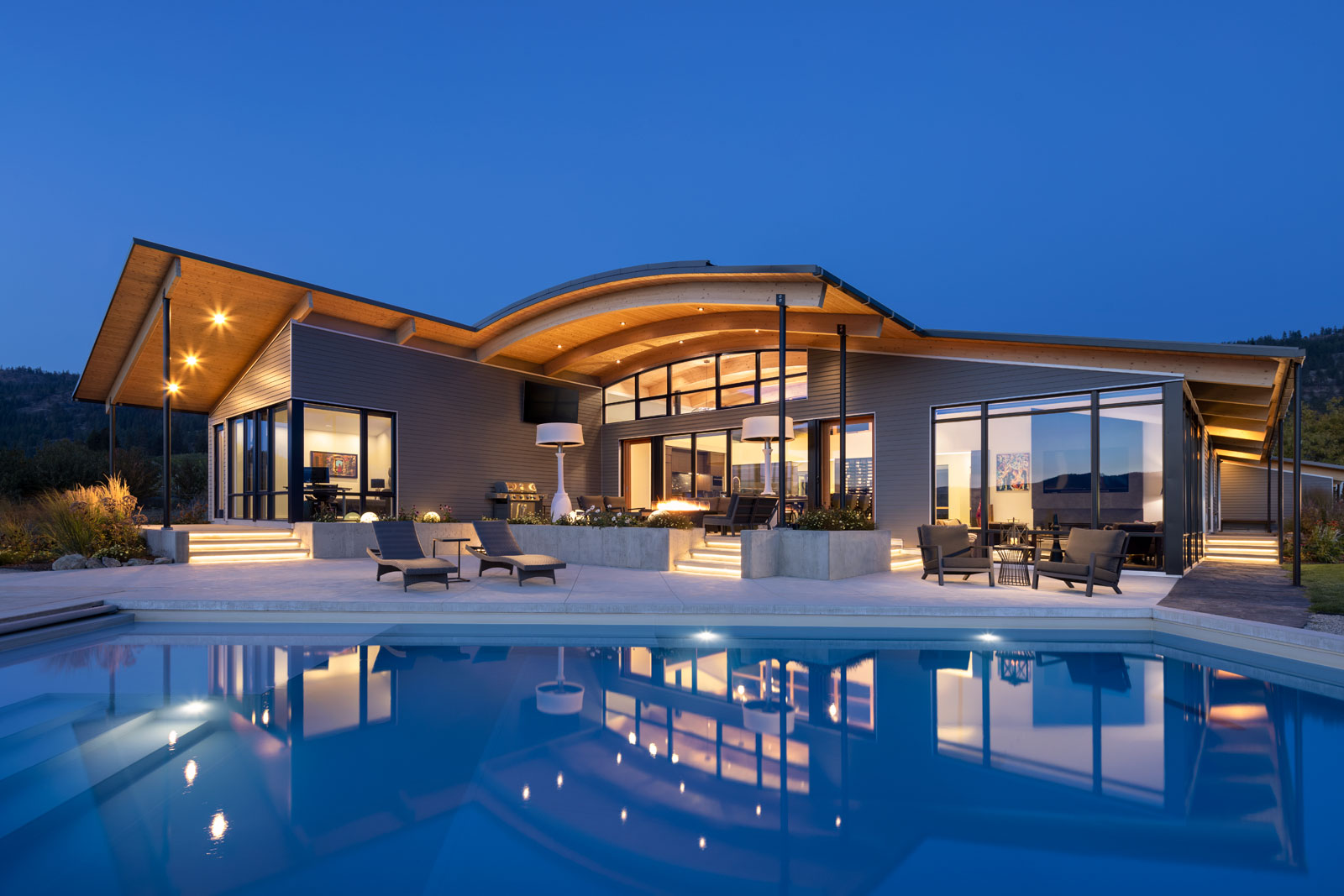 Architectural residential exterior timberframe luxury home at dusk in naramata okanagan for cover of Build Magazine