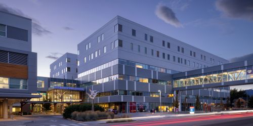 Exterior dusk architectural photograph by Shawn Talbot of Kelowna General Hospital with traffic in foreground
