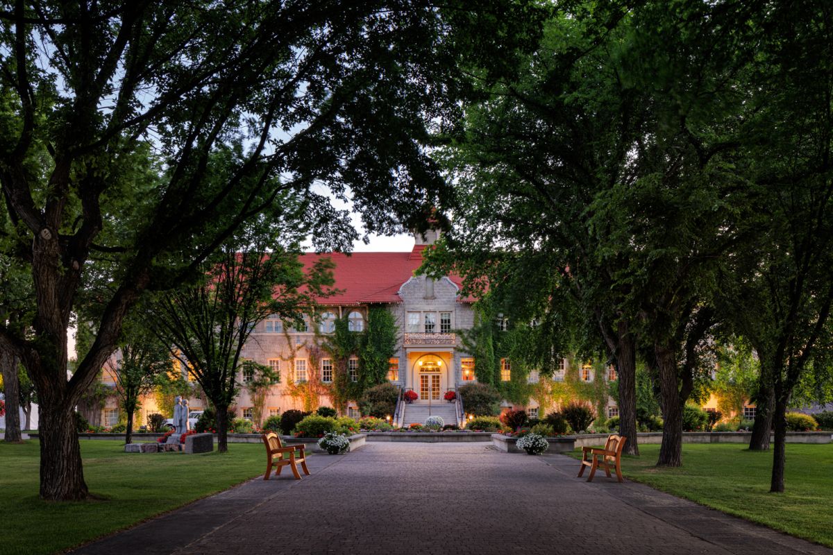 Dusk exterior architectural photograph by Shawn Talbot of St.Eugene Resort in Cranbrook front entry