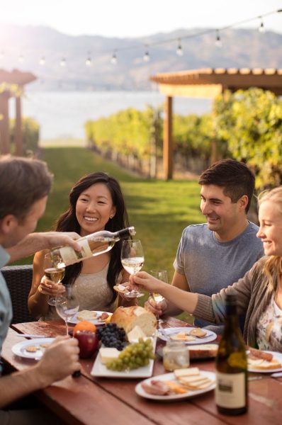 Shawn Talbot Commercial Photography couples enjoying wine and dinner overlooking Okanagan Lake