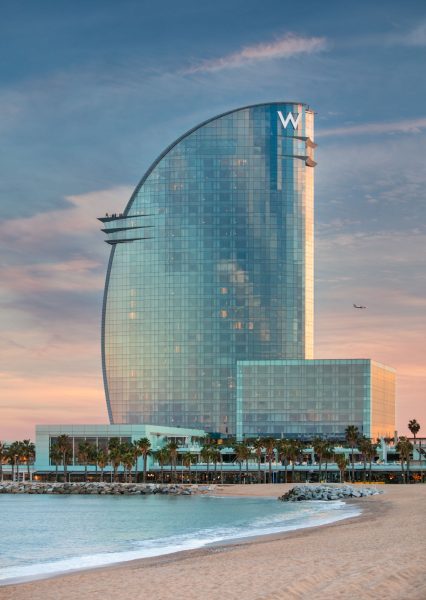 W Hotel Barcelona architectural exterior at twilight with beach and ocean