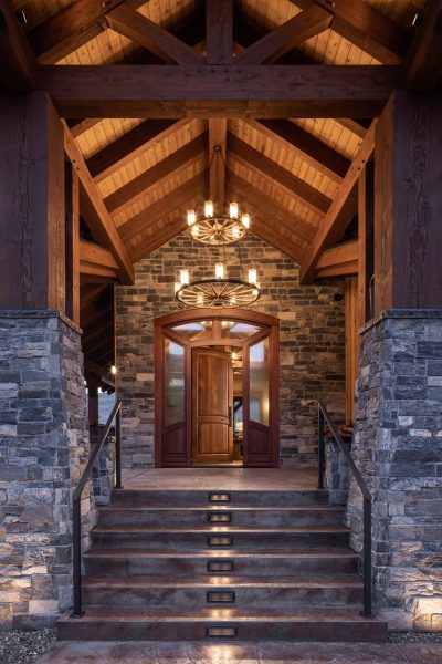 Luxury timberframe home front entryway at dusk by Shawn Talbot