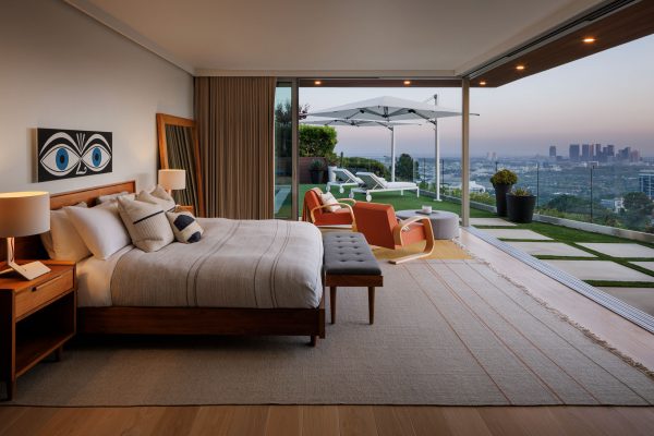 View over Hollywood from the primary bedroom of a luxury home at twilight