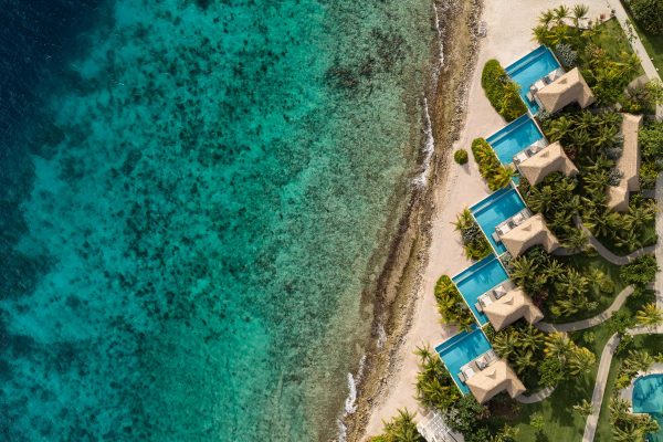 Sandals Resorts Curacao Aerial Drone Oceanfront Villas with blue caribbean water and white sand with swimming pools on the beach